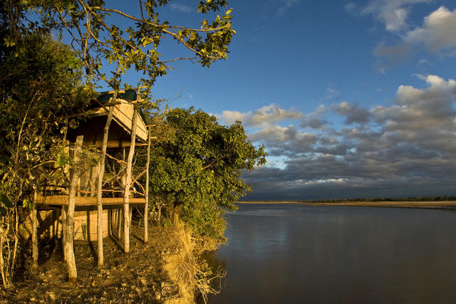 Each reed chalet is built on stilts, overlooking the Luangwa River