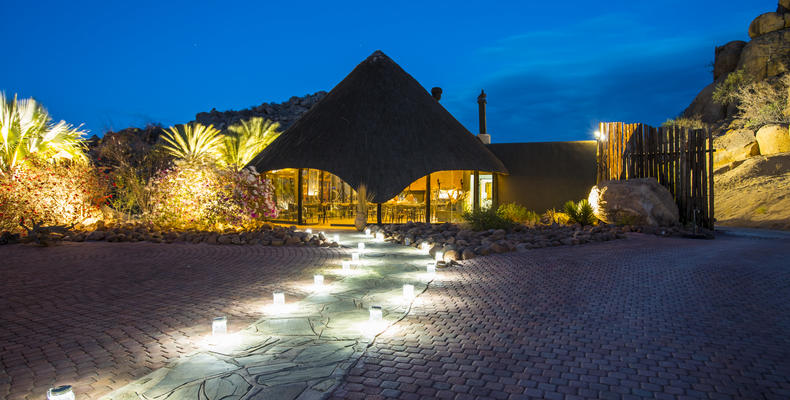 Lit pathway from chalets to restaurant