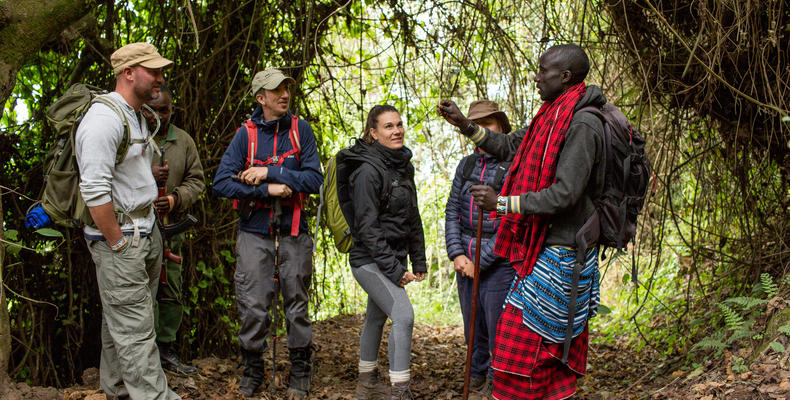 Alex, our local guide, explaining about the trees, flowers, plants and animals and how the Maasai use this as local medicine