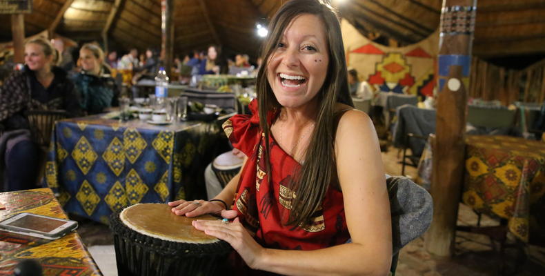 A guest enjoying the interactive drumming at the Boma - Dinner and Drum Show