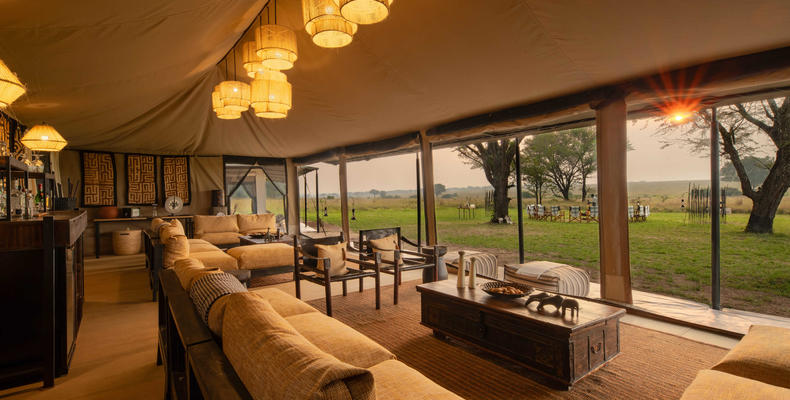 Ubuntu Camp - Main area lit up with sun peaking through at sunset