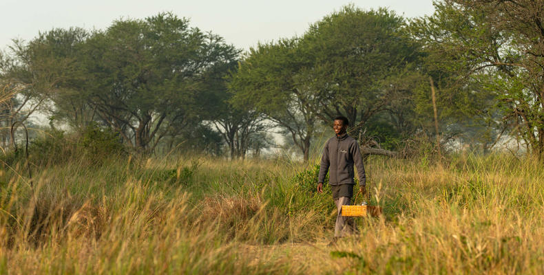 Ubuntu Camp - Staff member carrying a basket to room