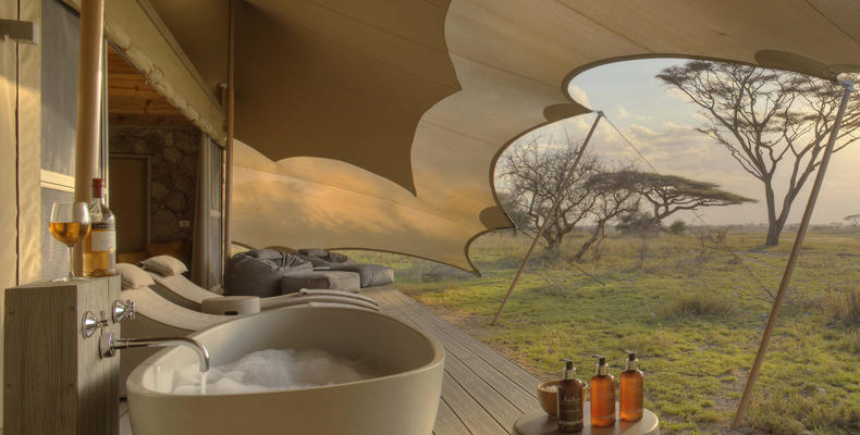 Namiri Plains - Tent Deck with Bath, Sunbeds and Cushion Corner