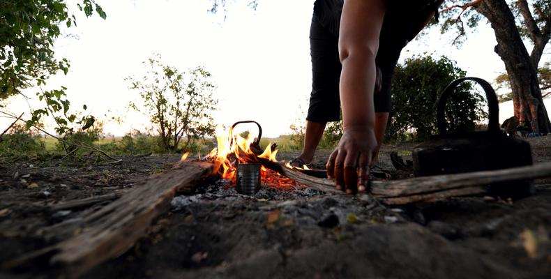 Chef starting dinner on the open fire