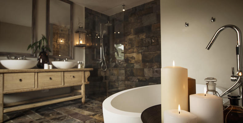 A luxurious en-suite bathroom with soaking tub and separate "rain" shower
