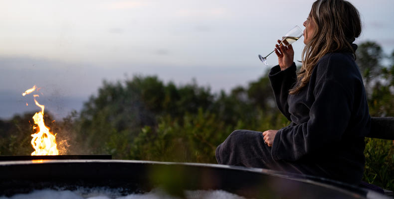 The Highlands - Guest Enjoying a Glass of Champagne at the Hot Tub