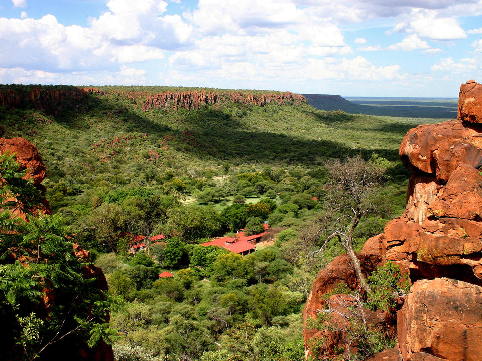View from the Waterberg plateau to Waterberg Wilderness Lodge in the valley of the private nature reserve of Waterberg Wilderness
